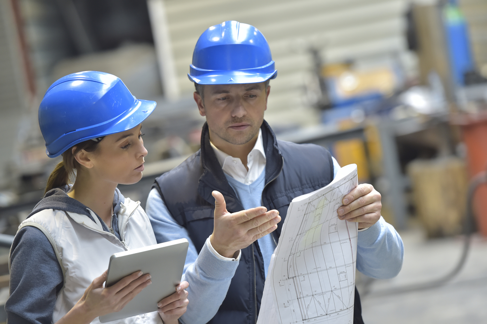 Engineers in mechanical factory reading instructions-1 Engineers in mechanical factory reading instructions-1
